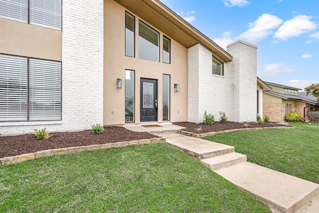 entrance to property with a yard