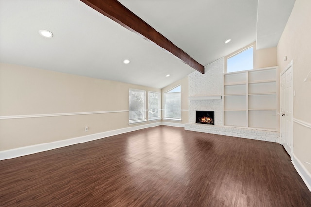 unfurnished living room with dark hardwood / wood-style flooring, vaulted ceiling with beams, a fireplace, and built in shelves