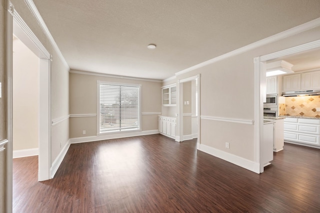 unfurnished living room with dark wood-type flooring, crown molding, and a textured ceiling