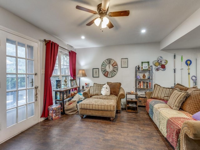 living room with dark wood-type flooring and ceiling fan