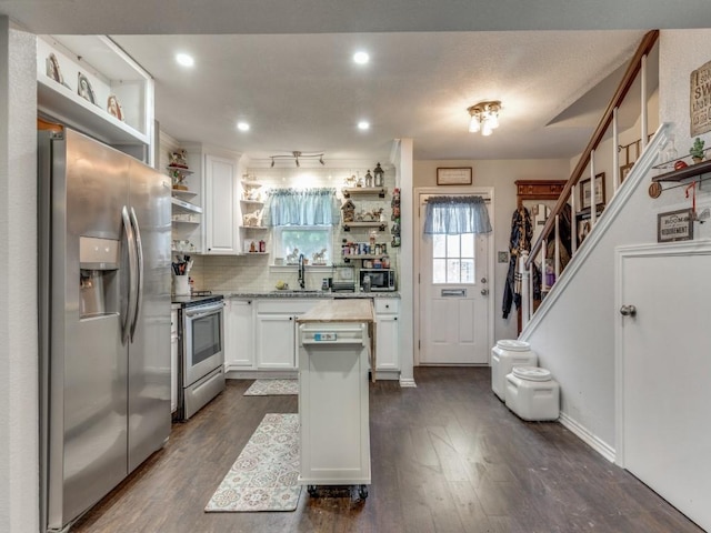 kitchen with sink, white cabinetry, stainless steel appliances, dark hardwood / wood-style floors, and tasteful backsplash