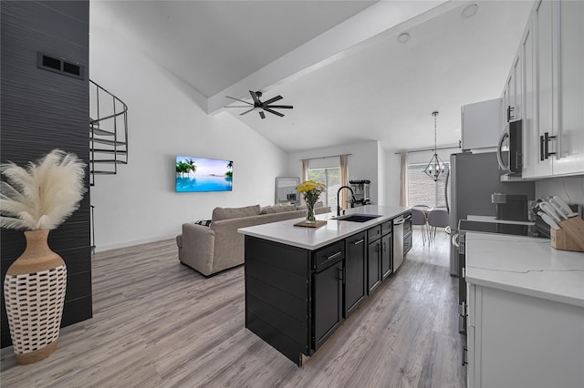 kitchen with sink, white cabinets, and light wood-type flooring