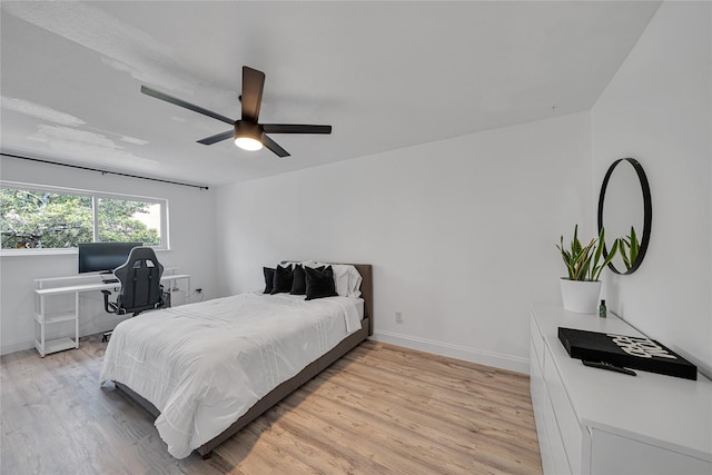 bedroom with light hardwood / wood-style floors and ceiling fan