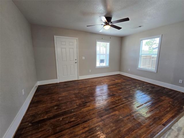 unfurnished room featuring ceiling fan, dark hardwood / wood-style floors, and a textured ceiling