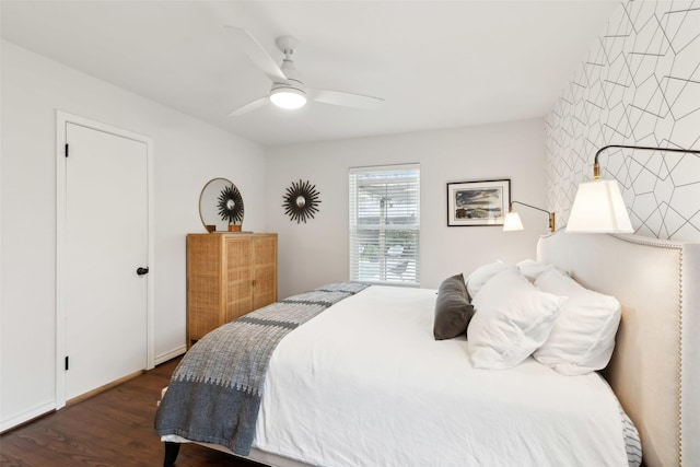 bedroom with ceiling fan and dark hardwood / wood-style flooring