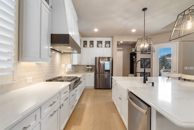 kitchen featuring stainless steel appliances, white cabinets, and glass insert cabinets