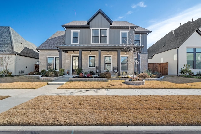 view of front of house featuring a front yard and covered porch