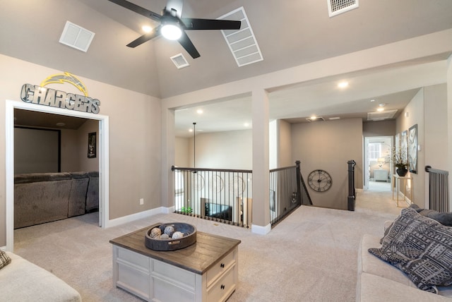 living area with light colored carpet, visible vents, and lofted ceiling