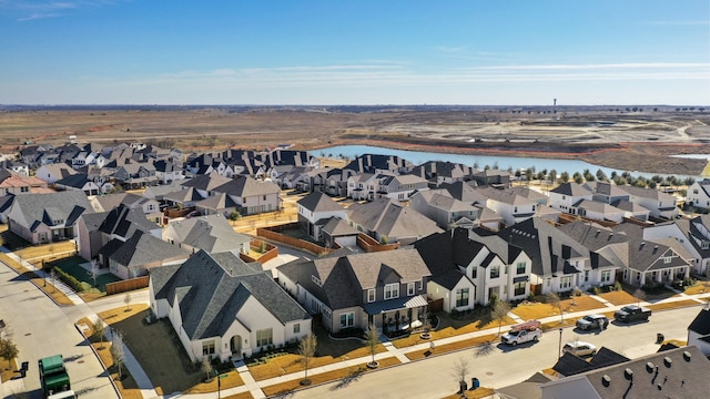 drone / aerial view featuring a residential view and a water view