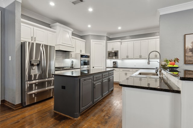 kitchen featuring sink, ornamental molding, white cabinets, and appliances with stainless steel finishes