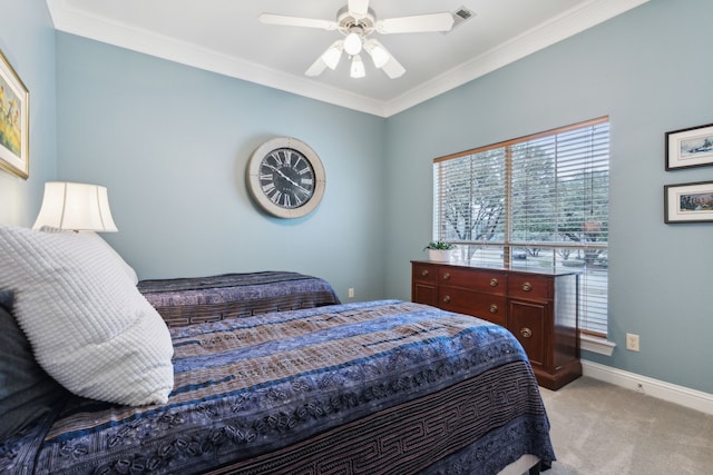 bedroom featuring crown molding, light colored carpet, and ceiling fan