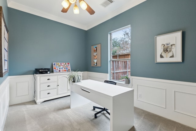 carpeted office space featuring crown molding and ceiling fan