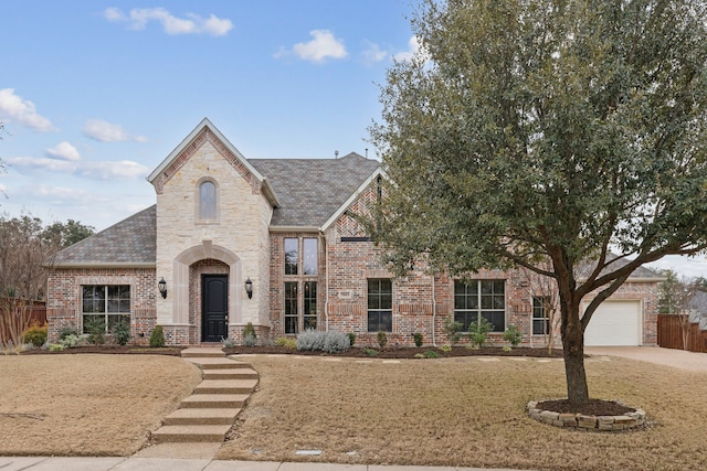 view of front of property with a garage and a front lawn