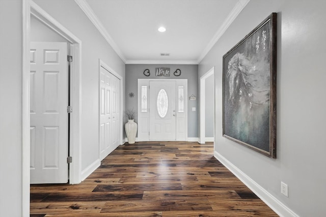 foyer entrance featuring crown molding and dark hardwood / wood-style floors