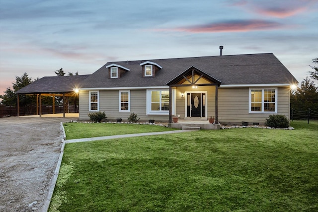 view of front facade featuring a carport and a yard