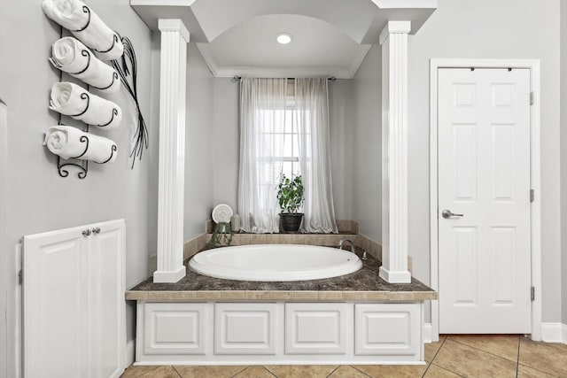 bathroom with crown molding, tile patterned floors, decorative columns, and a tub