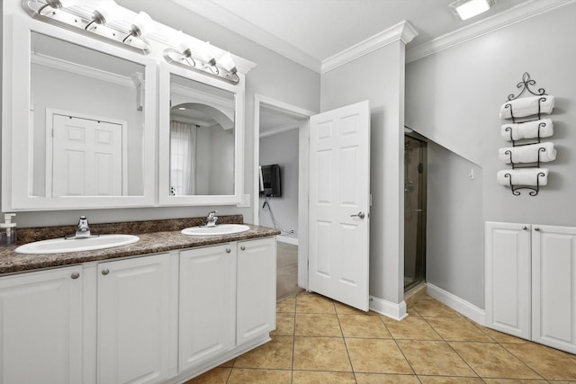 bathroom with tile patterned floors, ornamental molding, a shower with door, and vanity