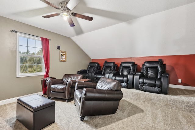 carpeted cinema room with ceiling fan and lofted ceiling