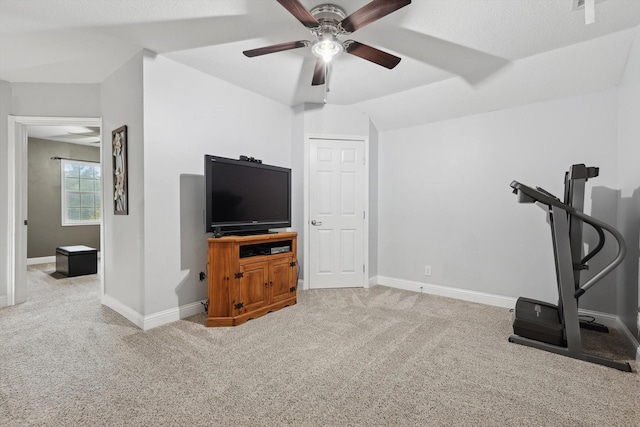 workout area featuring ceiling fan and light carpet