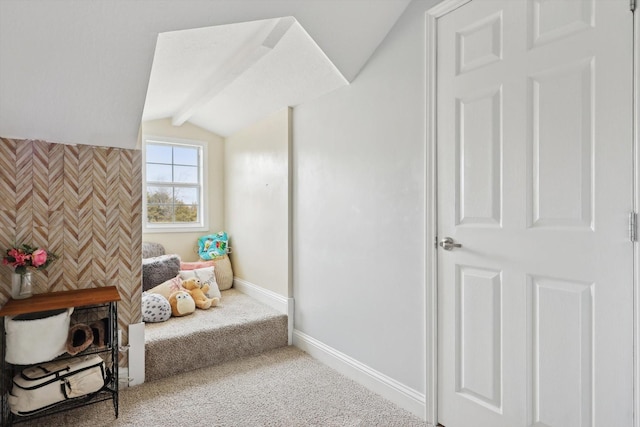 sitting room with carpet floors and vaulted ceiling with beams