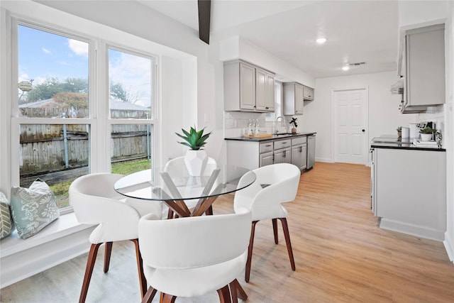 dining space featuring sink and light hardwood / wood-style flooring