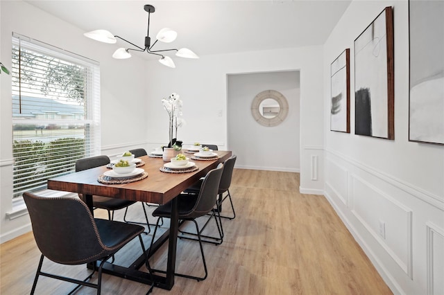 dining space featuring a notable chandelier and light hardwood / wood-style floors