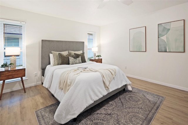 bedroom with ceiling fan and light wood-type flooring