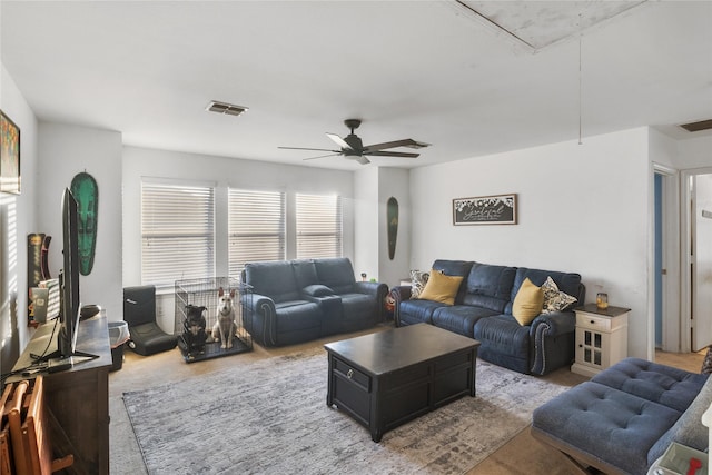 carpeted living room with ceiling fan