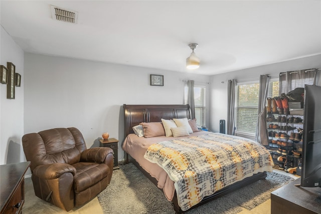 bedroom featuring light carpet and ceiling fan