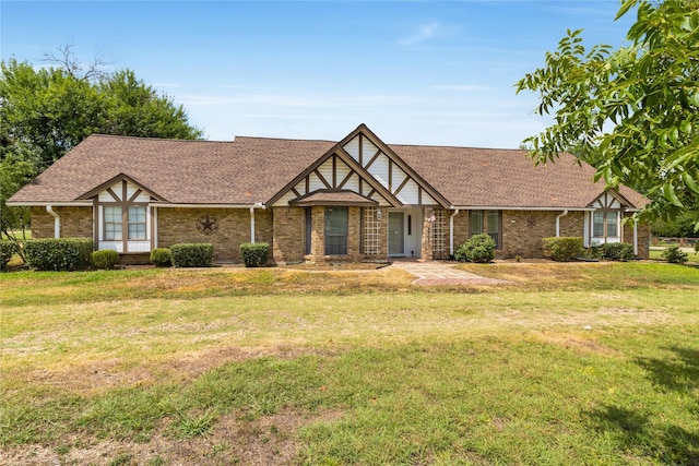 tudor house featuring a front yard