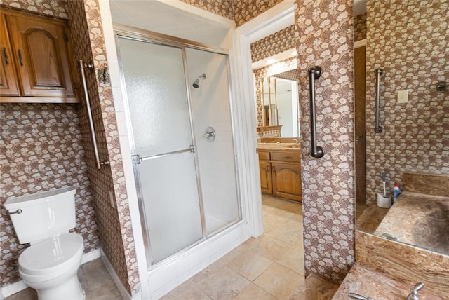 bathroom with vanity, toilet, and an enclosed shower