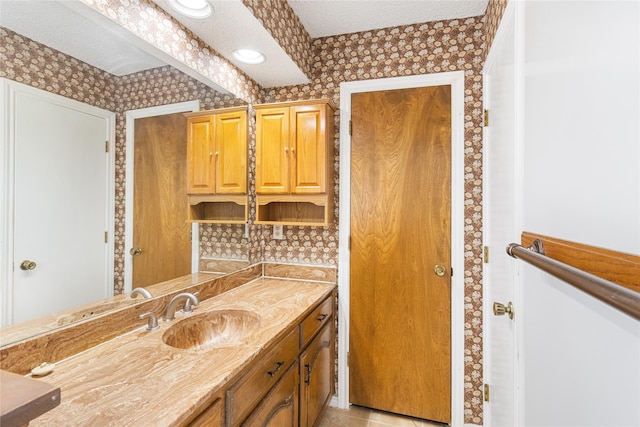 bathroom featuring vanity and a textured ceiling