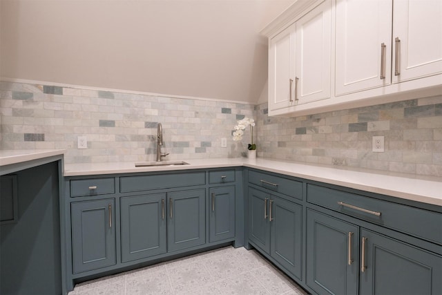 clothes washing area featuring sink and light tile patterned floors