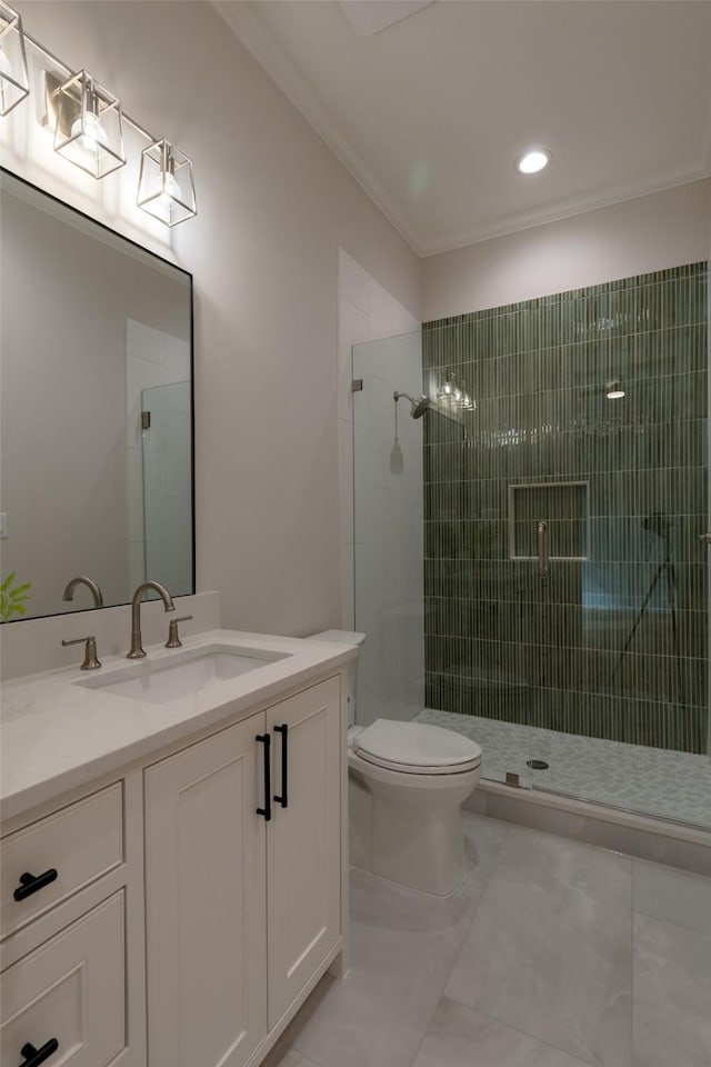 bathroom featuring vanity, ornamental molding, toilet, and a shower with shower door