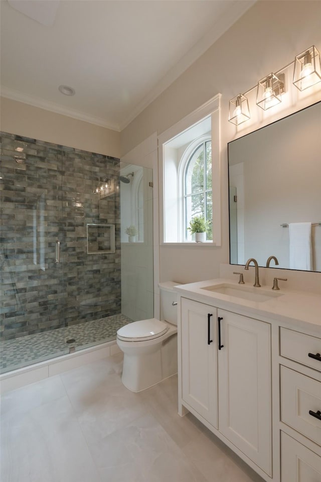 bathroom featuring ornamental molding, toilet, a shower with shower door, and vanity