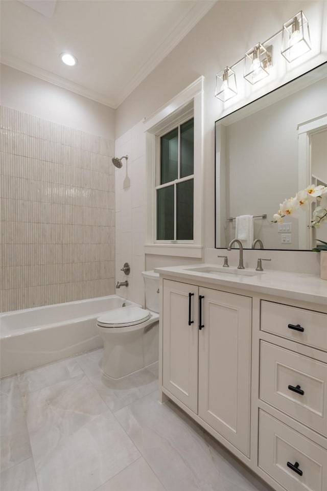 full bathroom with ornamental molding, toilet, vanity, and tiled shower / bath