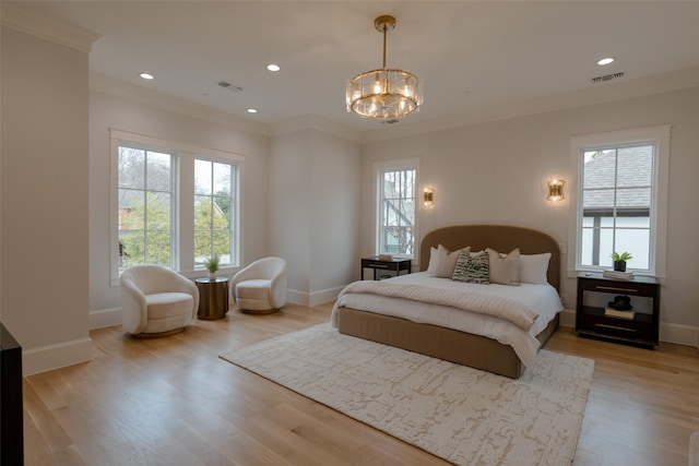 bedroom with multiple windows, ornamental molding, a notable chandelier, and light hardwood / wood-style floors