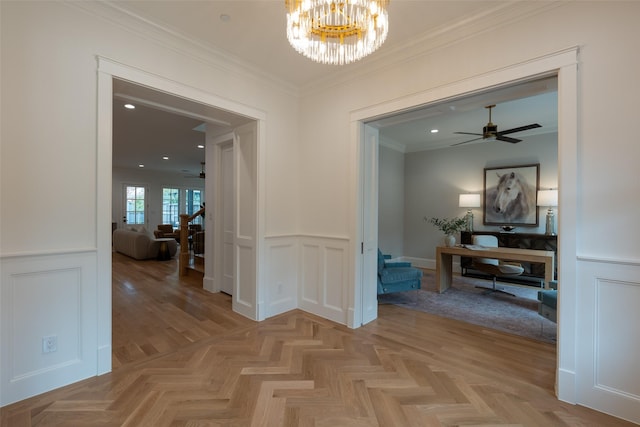 hallway with light parquet flooring, a chandelier, and crown molding