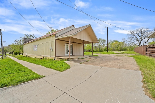 view of side of property with a lawn