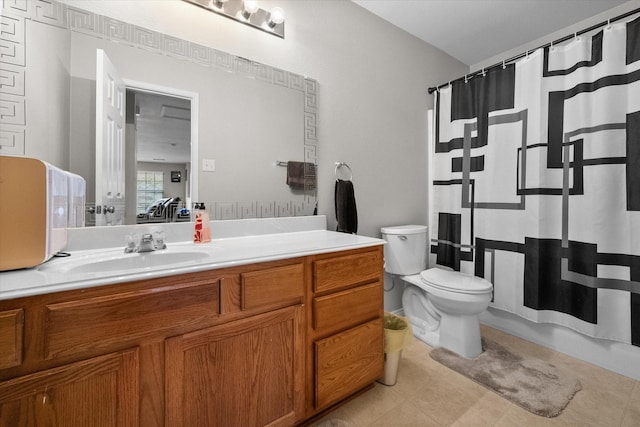 bathroom featuring tile patterned flooring, vanity, a shower with shower curtain, and toilet