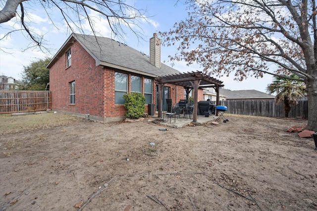 back of house featuring a pergola and a patio area