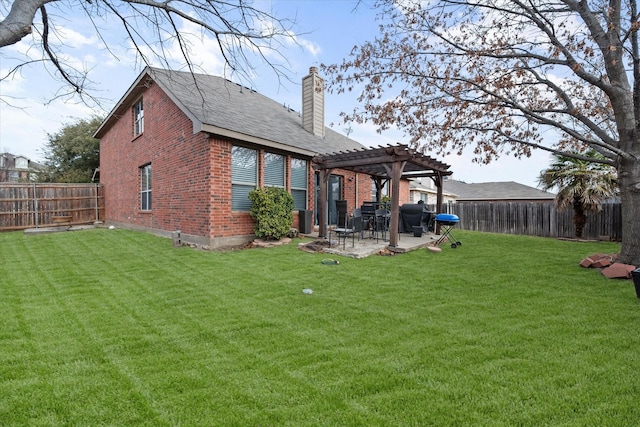 rear view of house with a pergola, a lawn, and a patio