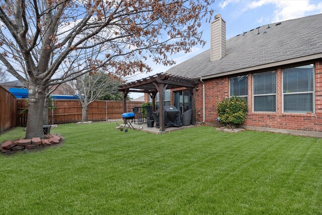 back of house with a pergola, a patio area, and a lawn