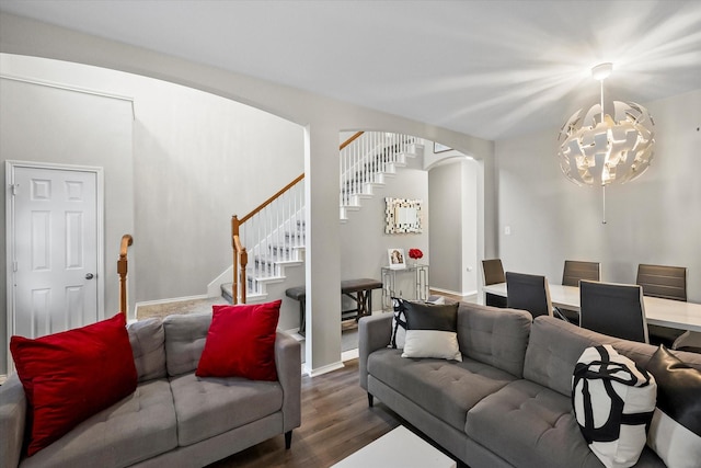 living room featuring dark wood-type flooring and a chandelier