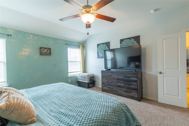 carpeted bedroom with vaulted ceiling and ceiling fan