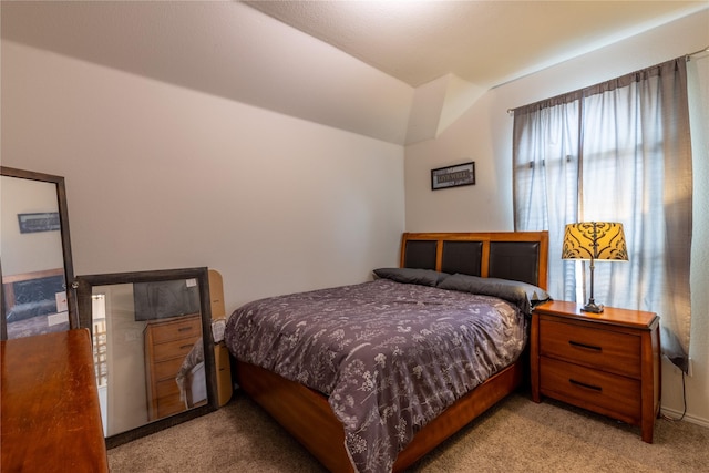 carpeted bedroom featuring lofted ceiling