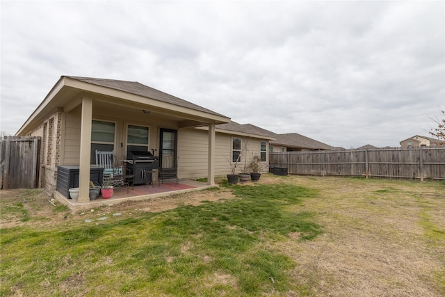 back of house featuring a yard and a patio area