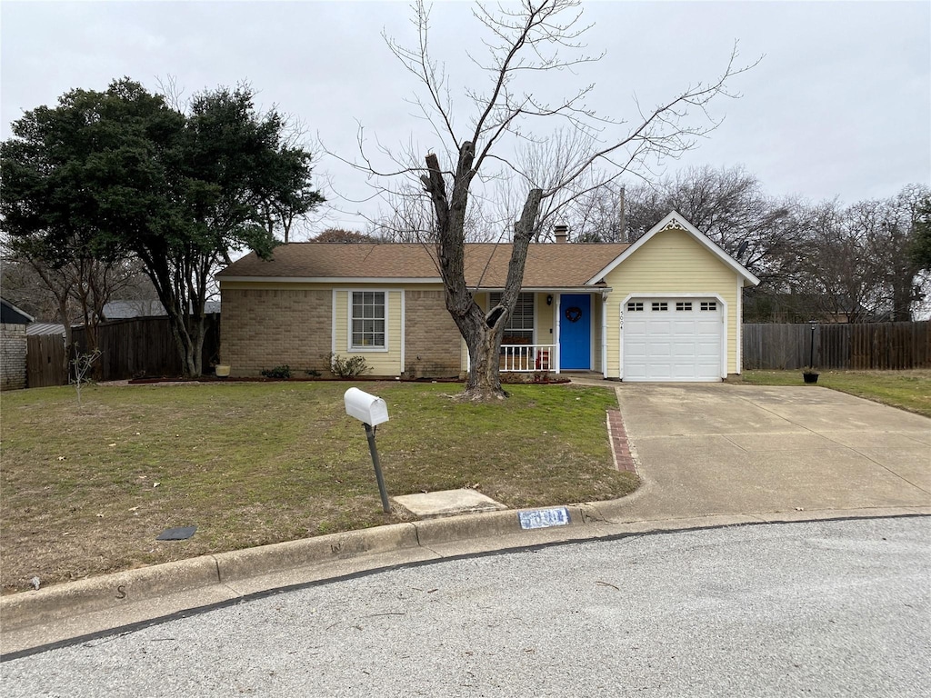 single story home with a garage and a front lawn