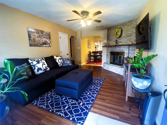 living room featuring hardwood / wood-style flooring, a fireplace, and ceiling fan