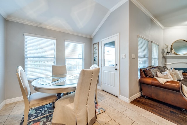 tiled dining space featuring crown molding and vaulted ceiling